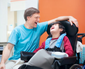 a child and his father laughing